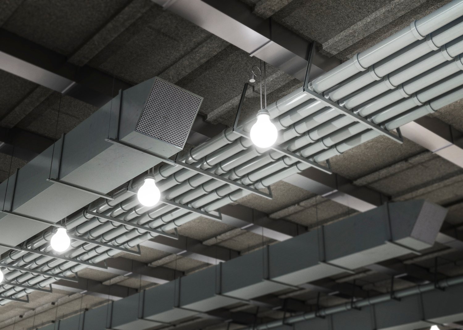 Exposed ceiling with industrial ventilation ducts, pipes, and hanging light bulbs.